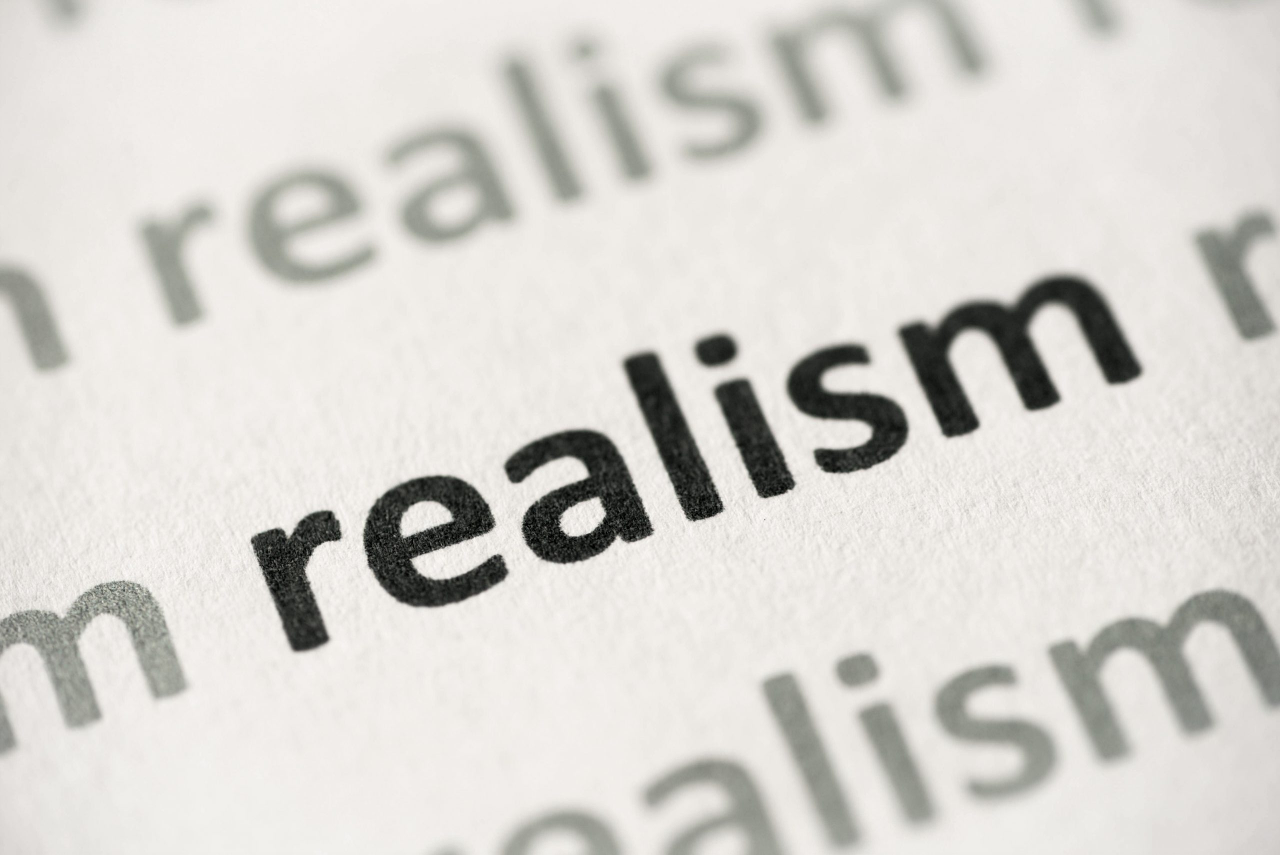 word realism printed on paper macro